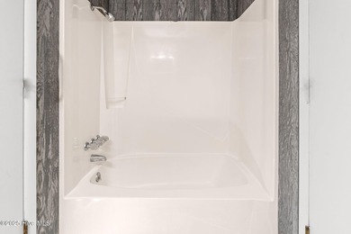 Charming Beach Cottage on Canal Lot with Boat Dock This is a on Sea Trail Golf Resort in North Carolina - for sale on GolfHomes.com, golf home, golf lot