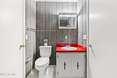 Charming Beach Cottage on Canal Lot with Boat Dock This is a on Sea Trail Golf Resort in North Carolina - for sale on GolfHomes.com, golf home, golf lot