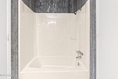 Charming Beach Cottage on Canal Lot with Boat Dock This is a on Sea Trail Golf Resort in North Carolina - for sale on GolfHomes.com, golf home, golf lot