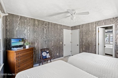 Charming Beach Cottage on Canal Lot with Boat Dock This is a on Sea Trail Golf Resort in North Carolina - for sale on GolfHomes.com, golf home, golf lot