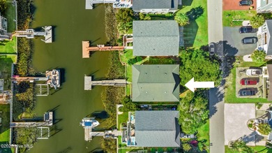 Charming Beach Cottage on Canal Lot with Boat Dock This is a on Sea Trail Golf Resort in North Carolina - for sale on GolfHomes.com, golf home, golf lot