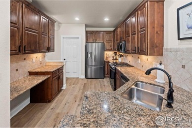 This stunning corner townhome backs to green space and offers a on Pelican Lakes Golf and Country Club in Colorado - for sale on GolfHomes.com, golf home, golf lot