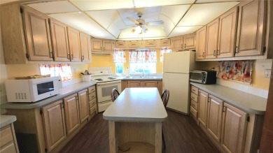 CHEERFUL HOME IN ACTIVE 55+ COMMUNITY! This one bed, two bath on River Run Golf Links in Florida - for sale on GolfHomes.com, golf home, golf lot