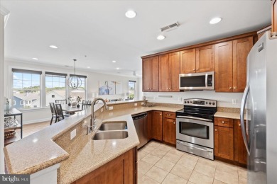 Discover your dream retreat in this stunning top-floor end unit on Bayside Resort Golf Club in Delaware - for sale on GolfHomes.com, golf home, golf lot