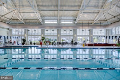 Discover your dream retreat in this stunning top-floor end unit on Bayside Resort Golf Club in Delaware - for sale on GolfHomes.com, golf home, golf lot