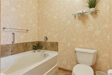 Spacious two-bedroom, two bathroom condo has walls of windows in on The Chaska Par 30 Golf Course in Minnesota - for sale on GolfHomes.com, golf home, golf lot