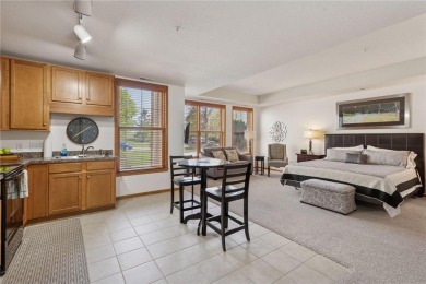 Spacious two-bedroom, two bathroom condo has walls of windows in on The Chaska Par 30 Golf Course in Minnesota - for sale on GolfHomes.com, golf home, golf lot