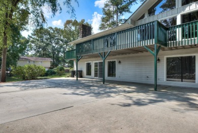 This contemporary stone and cedar West Lake home is nestled on a on West Lake Country Club in Georgia - for sale on GolfHomes.com, golf home, golf lot