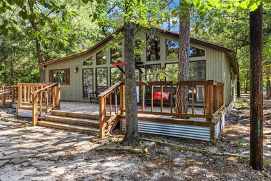 Welcome home to a warm and inviting retreat tucked away among on Holly Lake Ranch Golf Club in Texas - for sale on GolfHomes.com, golf home, golf lot