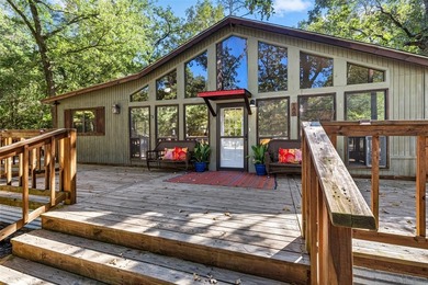 Welcome home to a warm and inviting retreat tucked away among on Holly Lake Ranch Golf Club in Texas - for sale on GolfHomes.com, golf home, golf lot