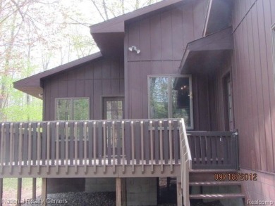 Welcome to 4010 Owl. This custom built Mahalak contemporary on Lost Lake Woods Club in Michigan - for sale on GolfHomes.com, golf home, golf lot