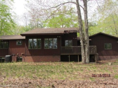 Welcome to 4010 Owl. This custom built Mahalak contemporary on Lost Lake Woods Club in Michigan - for sale on GolfHomes.com, golf home, golf lot