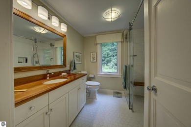 Nestled on an incredibly rare, private 2.47 wooded acres in on Leland Country Club in Michigan - for sale on GolfHomes.com, golf home, golf lot