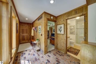 Nestled on an incredibly rare, private 2.47 wooded acres in on Leland Country Club in Michigan - for sale on GolfHomes.com, golf home, golf lot