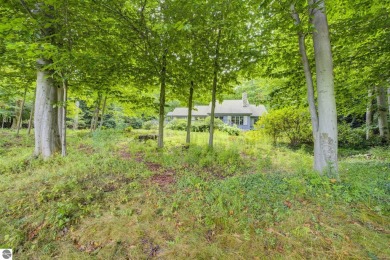 Nestled on an incredibly rare, private 2.47 wooded acres in on Leland Country Club in Michigan - for sale on GolfHomes.com, golf home, golf lot