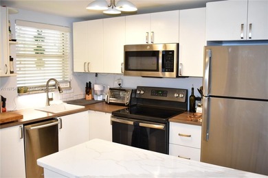 This first floor corner unit is facing the largest lake in on Sunrise Lakes Phase III in Florida - for sale on GolfHomes.com, golf home, golf lot