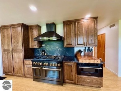 Discover 2,200 sq. ft. of luxurious, single-level living in this on Pine River Country Club in Michigan - for sale on GolfHomes.com, golf home, golf lot