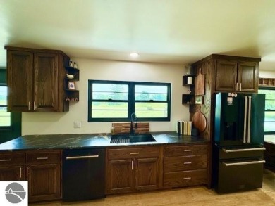 Discover 2,200 sq. ft. of luxurious, single-level living in this on Pine River Country Club in Michigan - for sale on GolfHomes.com, golf home, golf lot