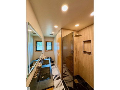 Discover 2,200 sq. ft. of luxurious, single-level living in this on Pine River Country Club in Michigan - for sale on GolfHomes.com, golf home, golf lot