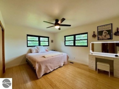 Discover 2,200 sq. ft. of luxurious, single-level living in this on Pine River Country Club in Michigan - for sale on GolfHomes.com, golf home, golf lot