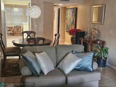 Serene golf course and water views from the large, screened on Flamingo Lakes Country Club in Florida - for sale on GolfHomes.com, golf home, golf lot