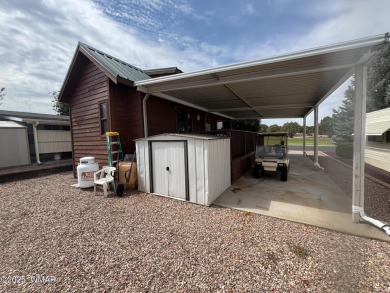 Get a cozy cabin feel in this charming home in desirable Juniper on Juniper Ridge R.V. Golf Resort in Arizona - for sale on GolfHomes.com, golf home, golf lot