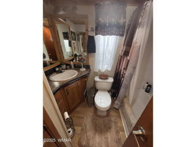 Get a cozy cabin feel in this charming home in desirable Juniper on Juniper Ridge R.V. Golf Resort in Arizona - for sale on GolfHomes.com, golf home, golf lot