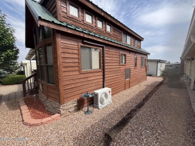 Get a cozy cabin feel in this charming home in desirable Juniper on Juniper Ridge R.V. Golf Resort in Arizona - for sale on GolfHomes.com, golf home, golf lot