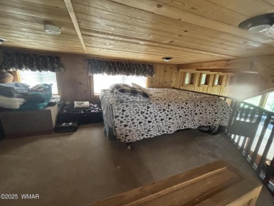 Get a cozy cabin feel in this charming home in desirable Juniper on Juniper Ridge R.V. Golf Resort in Arizona - for sale on GolfHomes.com, golf home, golf lot
