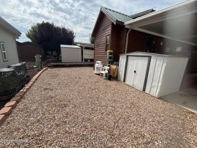 Get a cozy cabin feel in this charming home in desirable Juniper on Juniper Ridge R.V. Golf Resort in Arizona - for sale on GolfHomes.com, golf home, golf lot