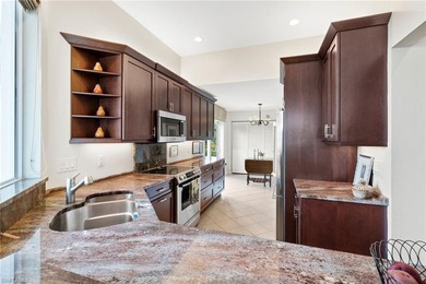 Enjoy spectacular panoramic lake and golf course views from this on Windstar on Naples Bay in Florida - for sale on GolfHomes.com, golf home, golf lot