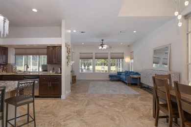 Beautifully updated with idyllic views of the fifteenth hole on Emerald Bay Golf Club in Florida - for sale on GolfHomes.com, golf home, golf lot