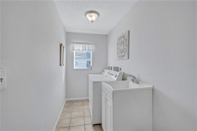 This elegant home features stunning hardwood floors throughout on Highland Lakes Executive Golf Course in Florida - for sale on GolfHomes.com, golf home, golf lot