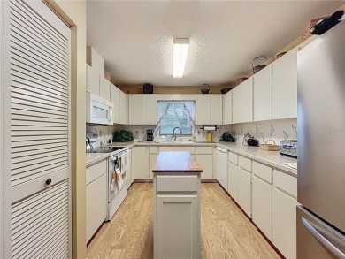 Welcome to this beautifully maintained 2-bedroom, 2-bath end on On Top of the World Golf Course in Florida - for sale on GolfHomes.com, golf home, golf lot