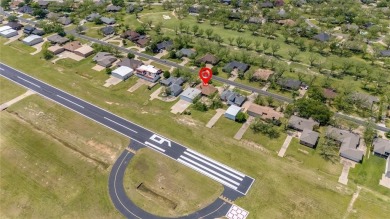Right off of the airstrip. Discover the perfect blend of luxury on Pecan Plantation Country Club in Texas - for sale on GolfHomes.com, golf home, golf lot