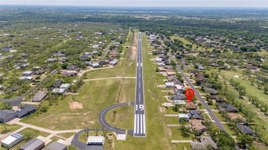 Right off of the airstrip. Discover the perfect blend of luxury on Pecan Plantation Country Club in Texas - for sale on GolfHomes.com, golf home, golf lot