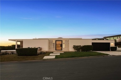 As waves break along Salt Creek Beach, evening lights shimmer on Monarch Beach Golf Links in California - for sale on GolfHomes.com, golf home, golf lot