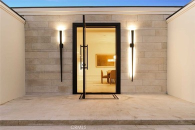 As waves break along Salt Creek Beach, evening lights shimmer on Monarch Beach Golf Links in California - for sale on GolfHomes.com, golf home, golf lot