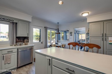 Welcome to 6106 Cutlass Court, a charming brick ranch-style home on Harbour Point Golf Club in North Carolina - for sale on GolfHomes.com, golf home, golf lot