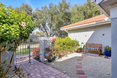 Walk through the front gate and courtyard to discover refined on The Meadows Golf and Country Club in Florida - for sale on GolfHomes.com, golf home, golf lot