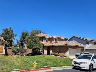 It's the well manicured looking home on a large lot backing the on Hemet Golf Club in California - for sale on GolfHomes.com, golf home, golf lot