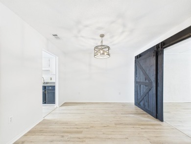 Secluded and beautifully updated, this charming 2-bedroom on Fairway Oaks at Magnolia Golf Course in Florida - for sale on GolfHomes.com, golf home, golf lot