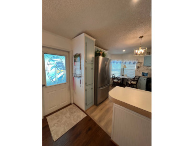 Delightful and meticulously maintained home, partially furnished on Lake Henry Golf Club in Florida - for sale on GolfHomes.com, golf home, golf lot