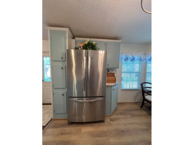 Delightful and meticulously maintained home, partially furnished on Lake Henry Golf Club in Florida - for sale on GolfHomes.com, golf home, golf lot