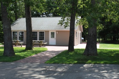 Ready to relax & enjoy yourself. This charming 2004 cottage on Marquette Trails Country Club in Michigan - for sale on GolfHomes.com, golf home, golf lot