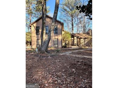 Tucked among mature trees and backing to the Rivermont golf on Rivermont Golf and Country Club in Georgia - for sale on GolfHomes.com, golf home, golf lot