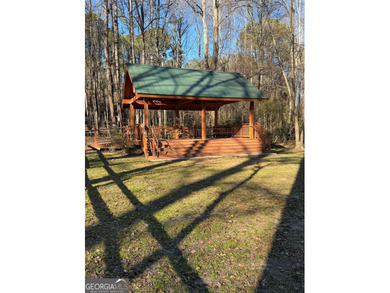 Tucked among mature trees and backing to the Rivermont golf on Rivermont Golf and Country Club in Georgia - for sale on GolfHomes.com, golf home, golf lot