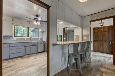 Discover this one-of-a-kind, three-level home nestled on two on Holiday Island Golf Course in Arkansas - for sale on GolfHomes.com, golf home, golf lot