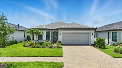 Impress guests with zero-corner sliding doors opening to an on Valencia Golf and Country Club in Florida - for sale on GolfHomes.com, golf home, golf lot