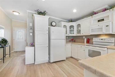 2005 Palm Harbor built home with an oversize one car garage and on Maple Leaf Golf and Country Club in Florida - for sale on GolfHomes.com, golf home, golf lot